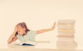 Stressed schoolgirl overwhelmed with too much homework hatting studying and school Royalty Free Stock Photo