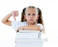 Stressed schoolgirl overwhelmed with too much homework hatting studying and school Royalty Free Stock Photo