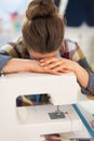 Stressed seamstress near sewing machine Royalty Free Stock Photo