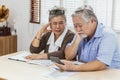 Stressed senior elderly couple conclict of credit card bills or bebt of expense in shopping. Lover financial risk or crisis and Royalty Free Stock Photo