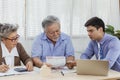 Stressed and serious retired Asian senior eldery couple consult with personal financial advisor or real estate agent about debt