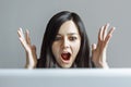 Stressed shocked business woman sitting at table in front of laptop looking stunned wide open mouth Royalty Free Stock Photo