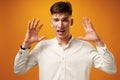 Stressed shouting young man holding hands near his head Royalty Free Stock Photo