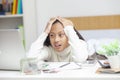 Stressed student woman memorizing on laptop studying sitting on a desk at home.Work from home