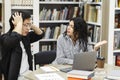 Stressed students preparing for examination in campus library Royalty Free Stock Photo