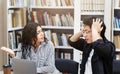 Stressed students preparing for examination in campus library Royalty Free Stock Photo