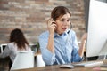 Stressed technical support operator working at table Royalty Free Stock Photo