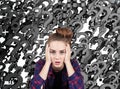 Stressed teen against black question marks Royalty Free Stock Photo