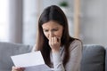 Stressed teen girl feeling worried reading bad news in letter Royalty Free Stock Photo