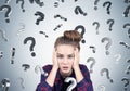 Stressed teen girl and question marks, gray Royalty Free Stock Photo