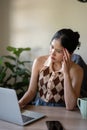 A stressed and thoughtful woman is working at her desk, making a solution plan to solve the problem Royalty Free Stock Photo