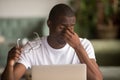 Stressed tired from computer work african man feeling eye strain Royalty Free Stock Photo
