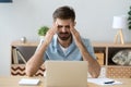 Stressed tired man having terrible headache after computer work Royalty Free Stock Photo