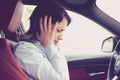 Stressed tired woman driver sitting inside her car having headache Royalty Free Stock Photo