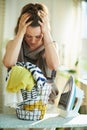 Woman with iron, clothes basket at modern home in sunny day Royalty Free Stock Photo