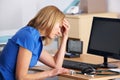 Stressed UK doctor sitting at desk