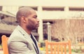 Stressed unhappy businessman sitting outside corporate office