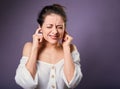 Stressed unhappy casual woman closed ears the fingers because not want the hear any sounds and noise