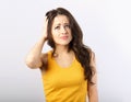 Stressed unhappy casual woman with headache looking up and holding the head the hand on blue background. Closeup Royalty Free Stock Photo