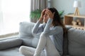 Stressed unhappy woman touching forehead, suffering from headache