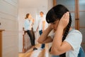 Stressed and unhappy young girl hide from domestic violence at home. Synchronos Royalty Free Stock Photo