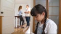 Stressed and unhappy young girl hide from domestic violence at home. Synchronos Royalty Free Stock Photo