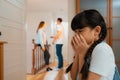 Stressed and unhappy young girl hide from domestic violence at home. Synchronos Royalty Free Stock Photo