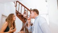 Unhappy young girl watch her parent arguing from the stair. Synchronos Royalty Free Stock Photo