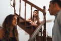 Unhappy young girl watch her parent arguing from the stair. Synchronos Royalty Free Stock Photo