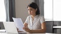 Stressed upset asian business woman reading bad news in paper Royalty Free Stock Photo