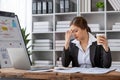 Stressed and upset Asian female office worker looking at her laptop screen, pensive Royalty Free Stock Photo