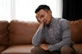 Stressed and upset Asian man is covering his face, crying about his failures in life Royalty Free Stock Photo