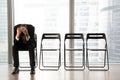 Stressed upset businessman sitting on chair, received bad news.