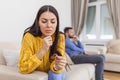 Stressed wife holding her wedding ring worried about breakup or divorce, avoid talking with husband after fight, anxious couple