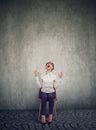 Stressed woman company employee sitting on a chair screaming in desperation