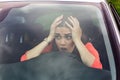 Stressed woman driver sitting inside her car. Angry female driver driving a car. Angry young woman stuck in a traffic jam. Woman Royalty Free Stock Photo