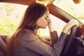 Stressed woman driver sitting inside her car