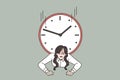 Stressed businesswoman trapped by clock distressed with deadline