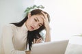 Stressed woman feeling tired and worry about work problem looking at laptop