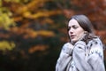 Stressed woman getting cold in autumn in a park Royalty Free Stock Photo