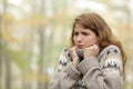 Stressed woman getting cold in winter in a park