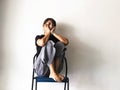 Stressed woman sitting with a knee high and hence to rest chin on her hand.with upset,unhappy feeling,depressive disorder syndrome