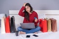 stressed woman using laptop for online shopping on bed, and having problem with blocked credit card Royalty Free Stock Photo