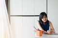 Stressed woman using tablet managing debt,House bills with taxes and bank account balance Royalty Free Stock Photo