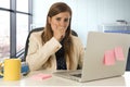 Stressed woman working with laptop computer on desk in overworked Royalty Free Stock Photo