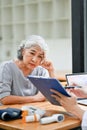 A stressed and worried Asian retired old lady patient is being diagnosed from a doctor in a hospital Royalty Free Stock Photo