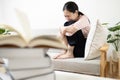 Stressed worried asian teenage girl cries while reading textbooks before exams,stress and pressure of studying for an exam,prepare Royalty Free Stock Photo