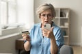 Stressed worried elderly pensioner woman having problems with credit card Royalty Free Stock Photo