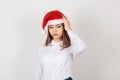 Stressed worried unhappy young woman in Christmas hat, looking down, having headache migraine isolated white background. Having Royalty Free Stock Photo