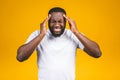 Stressed young african american man feel pain having terrible strong headache concept, tired upset black guy massaging temples Royalty Free Stock Photo